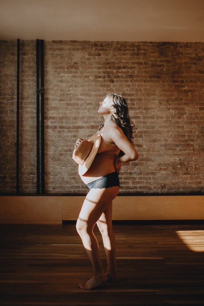 Naked pregnant woman during maternity session in nyc home