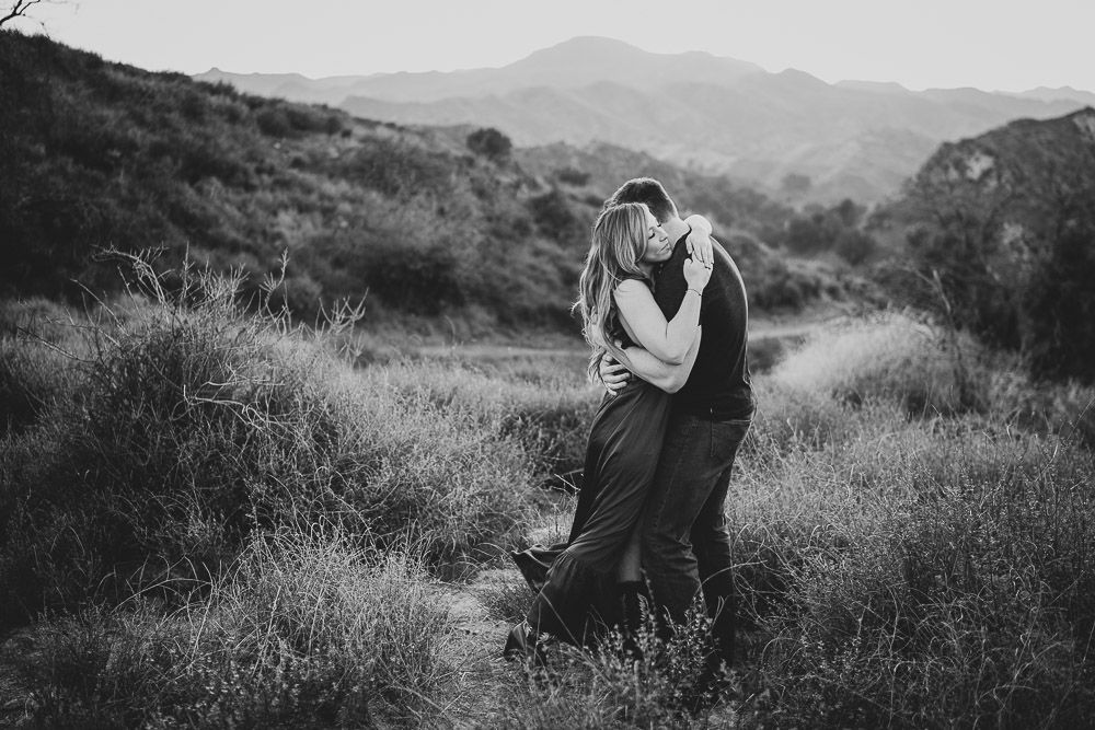 Couple cuddles during engagement session in los angeles canyon