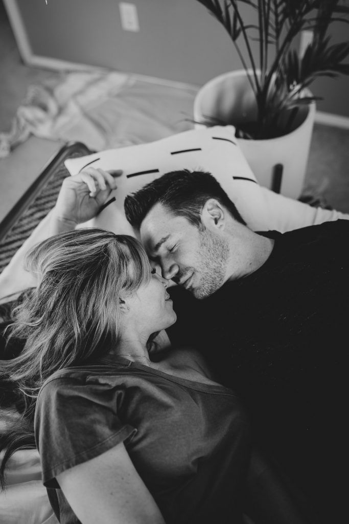 Couple cuddles in bed during in home session in brooklyn