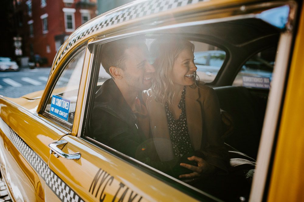Couple by old taxi cab during nyc engagement photoshoot