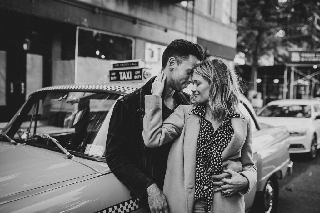 Couple by old taxi cab during nyc engagement photoshoot