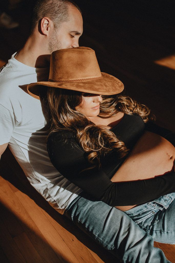 Expecting couple during intimate maternity session in nyc home
