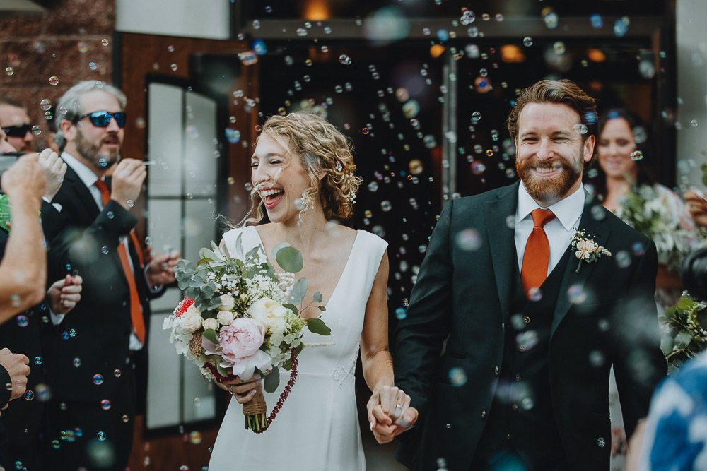 Bride and groom bubble exit after hudson valley wedding ceremony