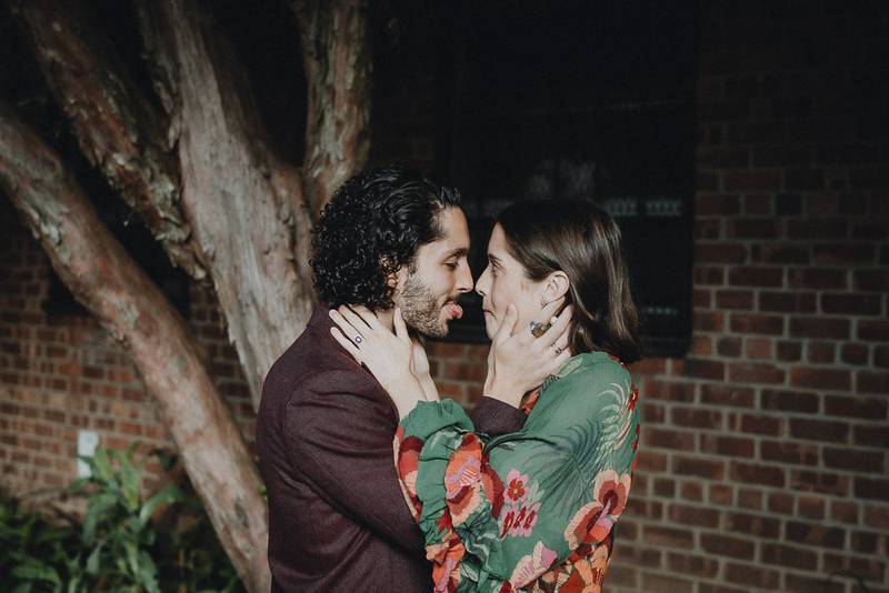 Couple being silly in brooklyn backyard during elopement
