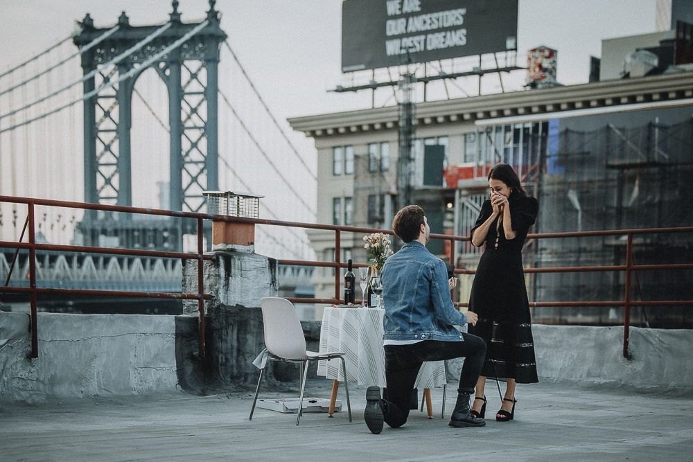 Couple on dumbo rooftop during brooklyn proposal