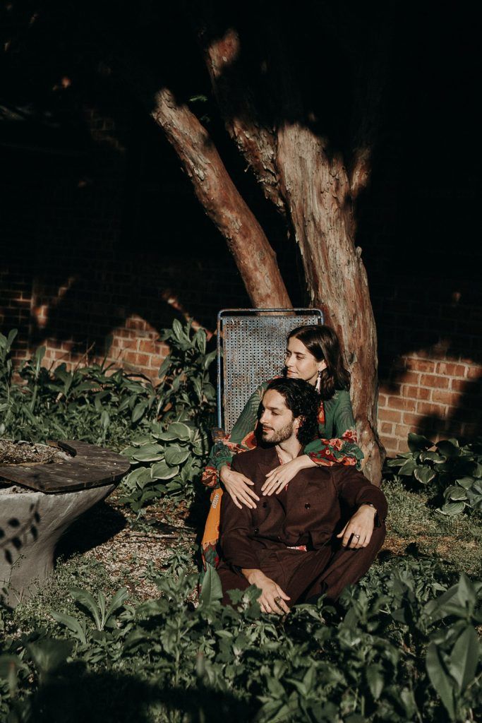 Couple sitting down in brooklyn backyard during elopement