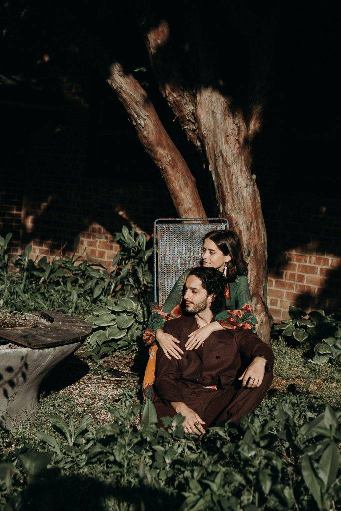 Couple sitting down in brooklyn backyard during elopement