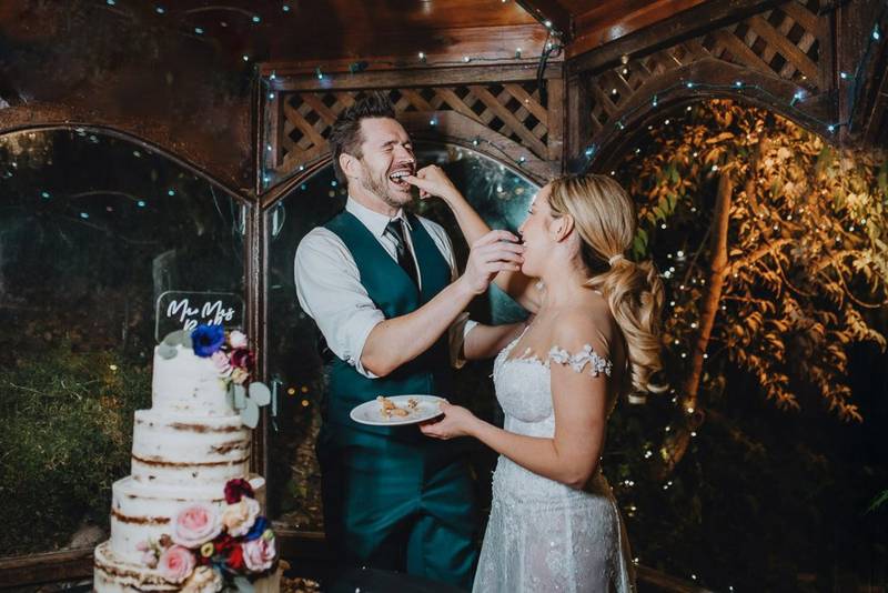 Bride and groom cutting cake at los angeles wedding