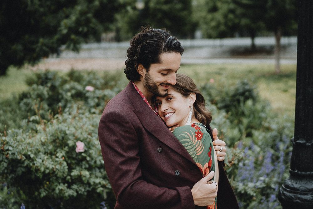 Bride nestles in groom's chest during elopement in brooklyn park