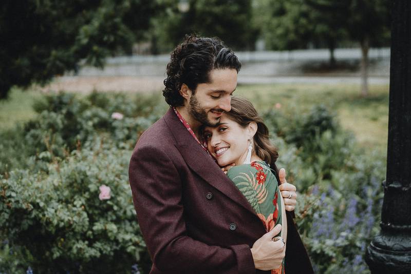 Bride nestles in groom's chest during elopement in brooklyn park