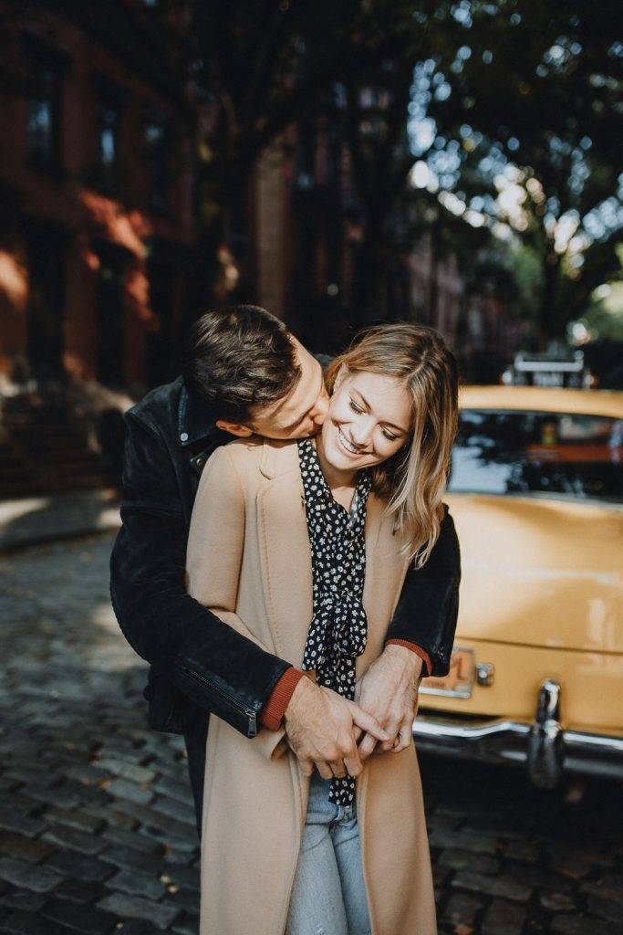 Couple by old taxi cab during nyc engagement photoshoot