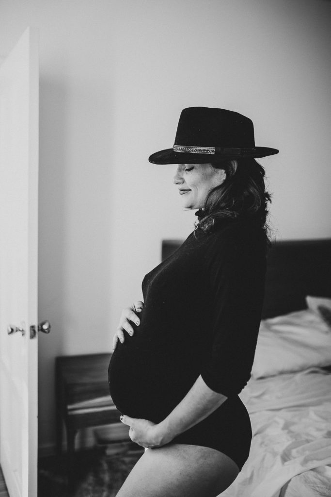 Pregnant woman with black bodysuit during maternity photoshoot in brooklyn home