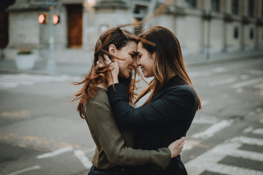 Lesbian couple kissing in nyc street during engagement session