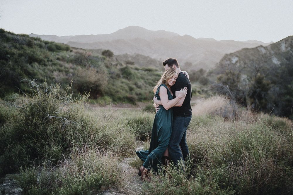 Couple cuddles during engagement session in los angeles canyon