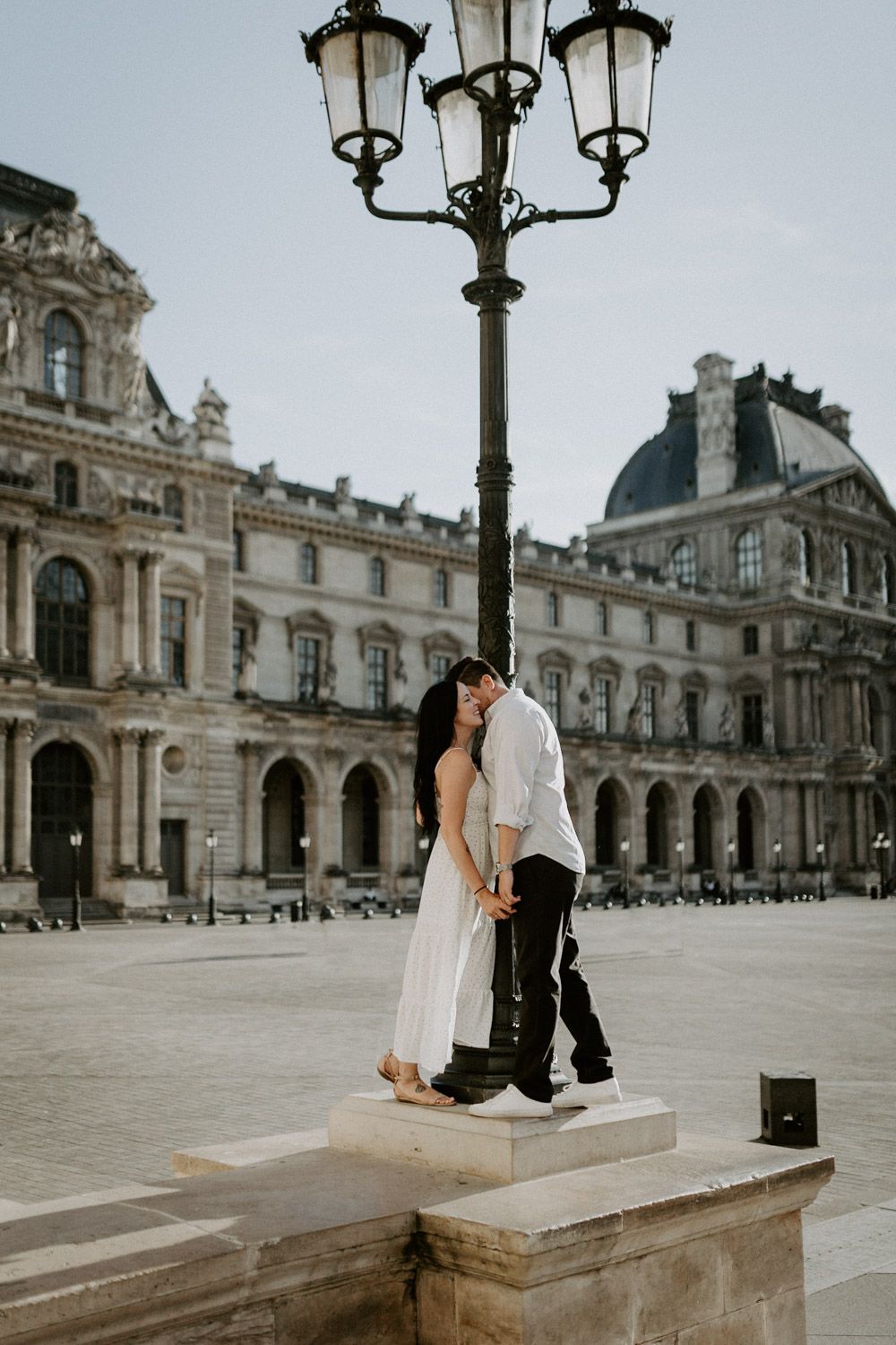 Couple during Paris engagement photoshoot at le louvre