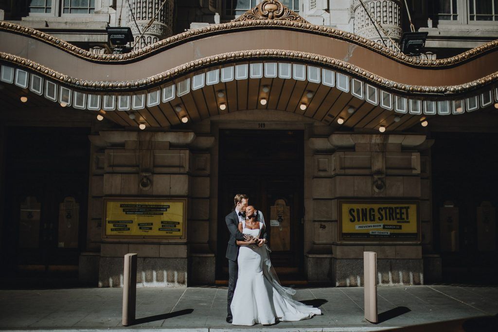 Interracial bride and groom at nyc wedding in theatre district
