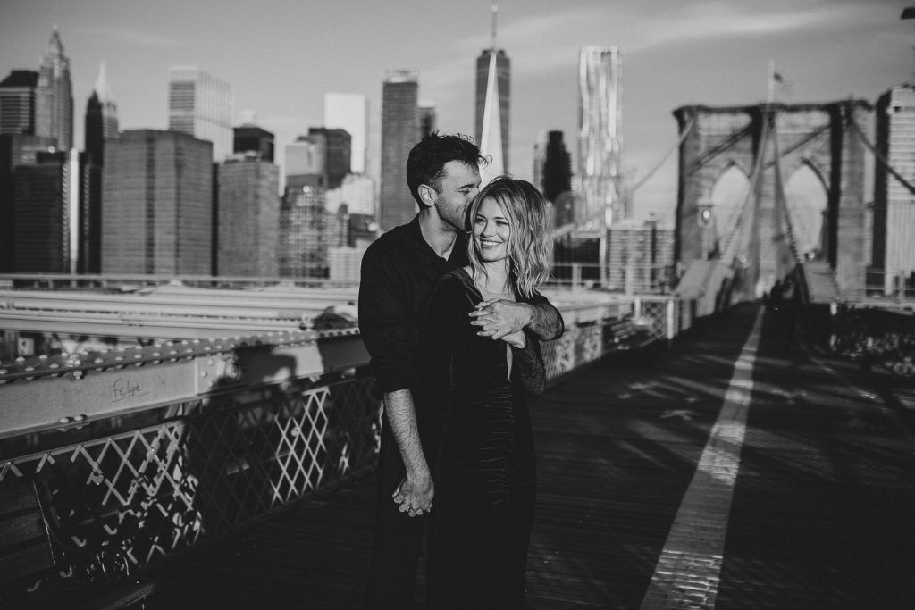 Couple on brooklyn bridge at sunrise during elopement photoshoot