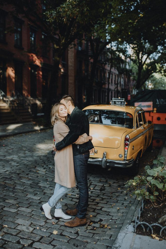 Couple by old taxi cab during nyc engagement photoshoot