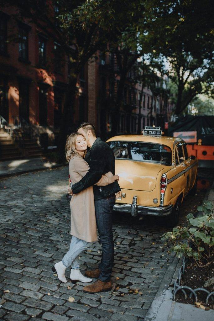 Couple by old taxi cab during nyc engagement photoshoot