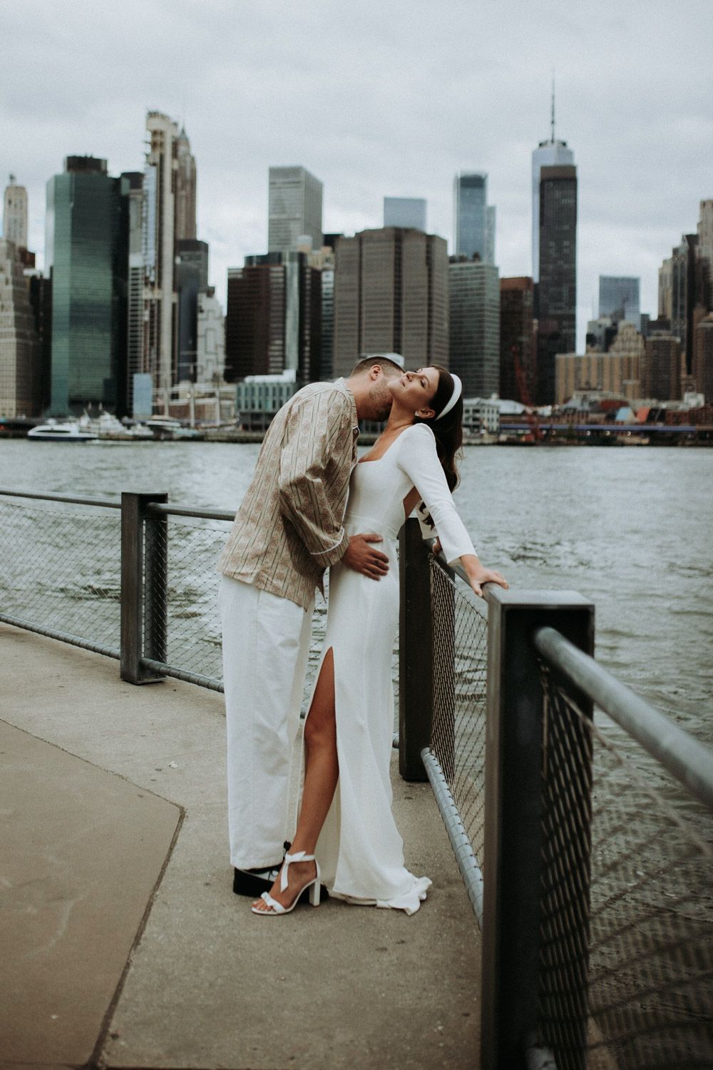 Bride and groom portrait in dumbo by nyc skyline