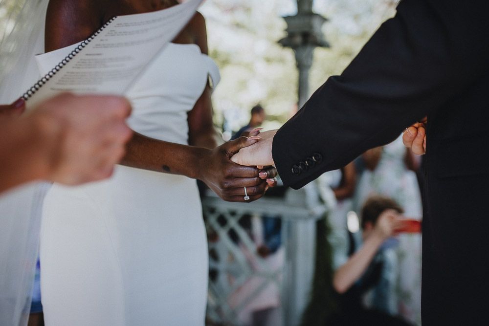 Wedding ceremony of biracial bride and groom in central park