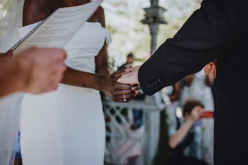 Wedding ceremony of biracial bride and groom in central park