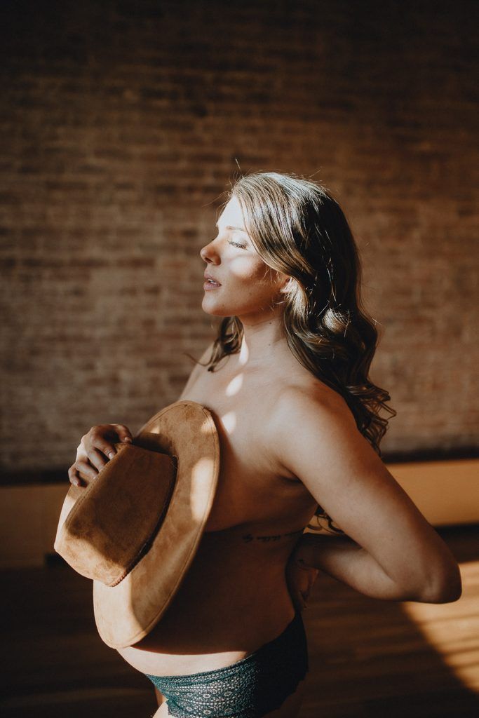 Naked pregnant woman during maternity session in nyc home