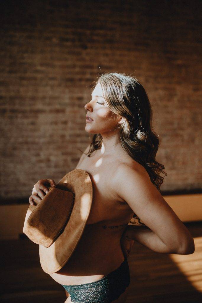 Naked pregnant woman during maternity session in nyc home