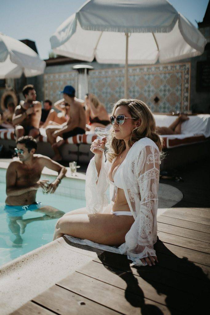 Bride at petit ermitage hotel pool in los angeles on wedding day