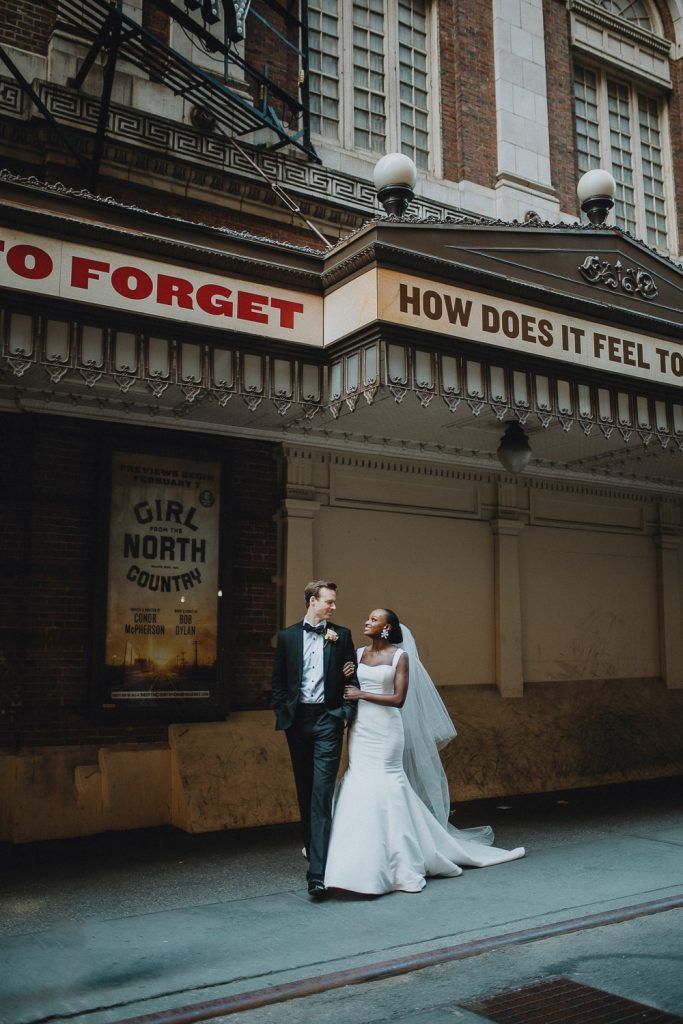 Interracial bride and groom at nyc wedding in theatre district