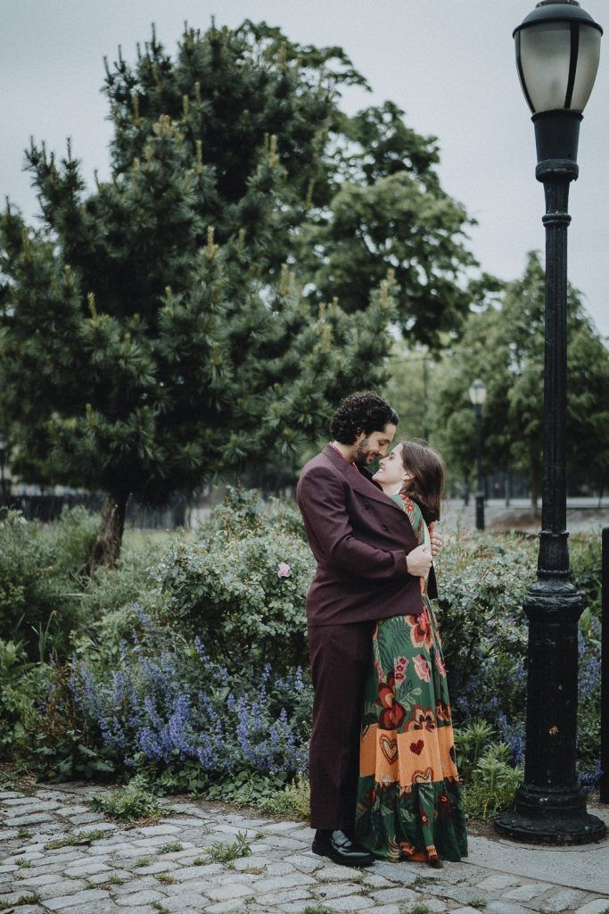 Bride nestles in groom's chest during elopement in brooklyn park