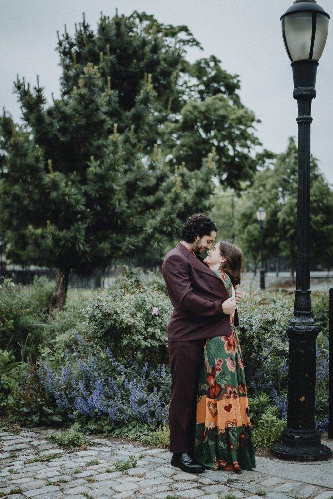Bride nestles in groom's chest during elopement in brooklyn park