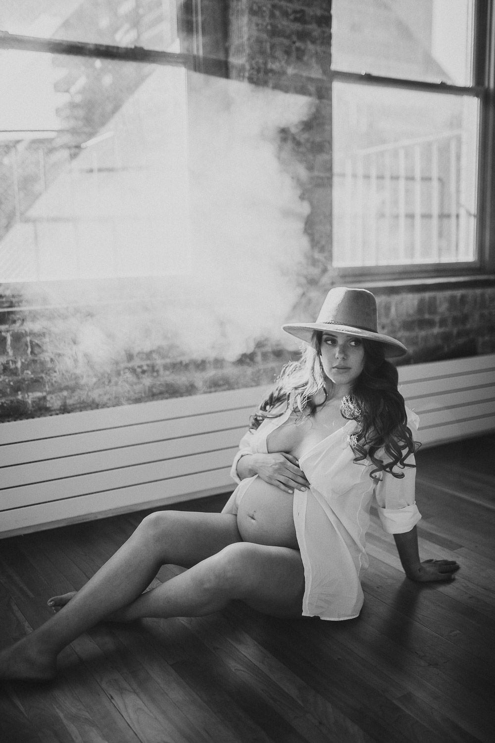 Naked pregnant woman during maternity session in nyc home