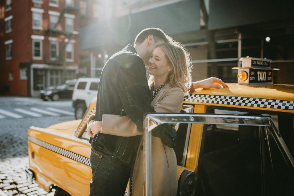 Couple by old taxi cab during nyc engagement photoshoot
