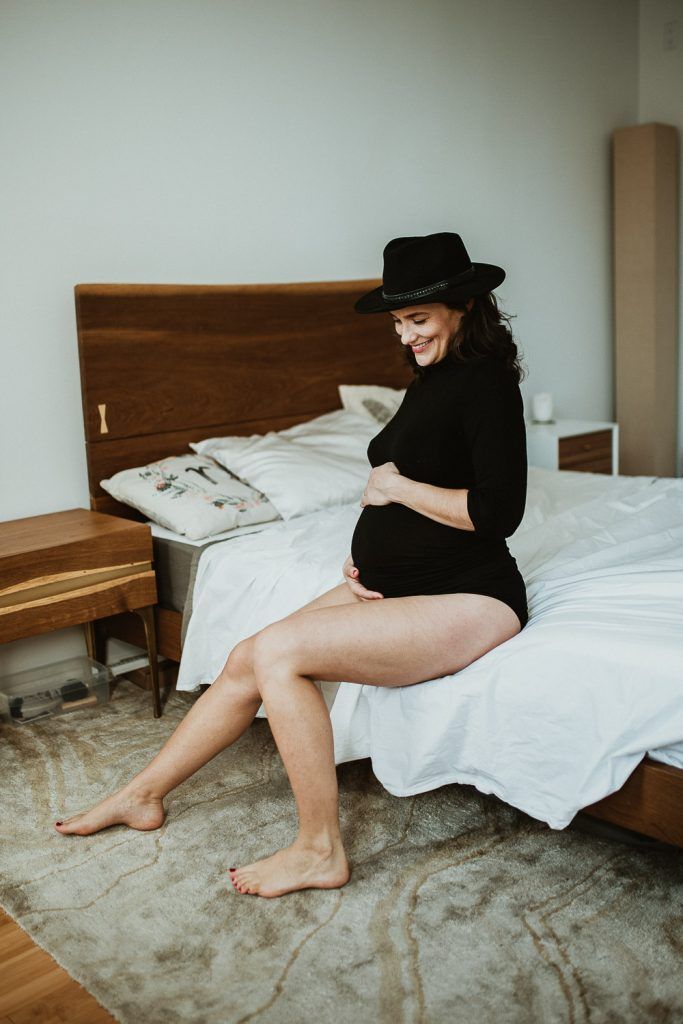 Pregnant woman with black bodysuit during maternity photoshoot in brooklyn home