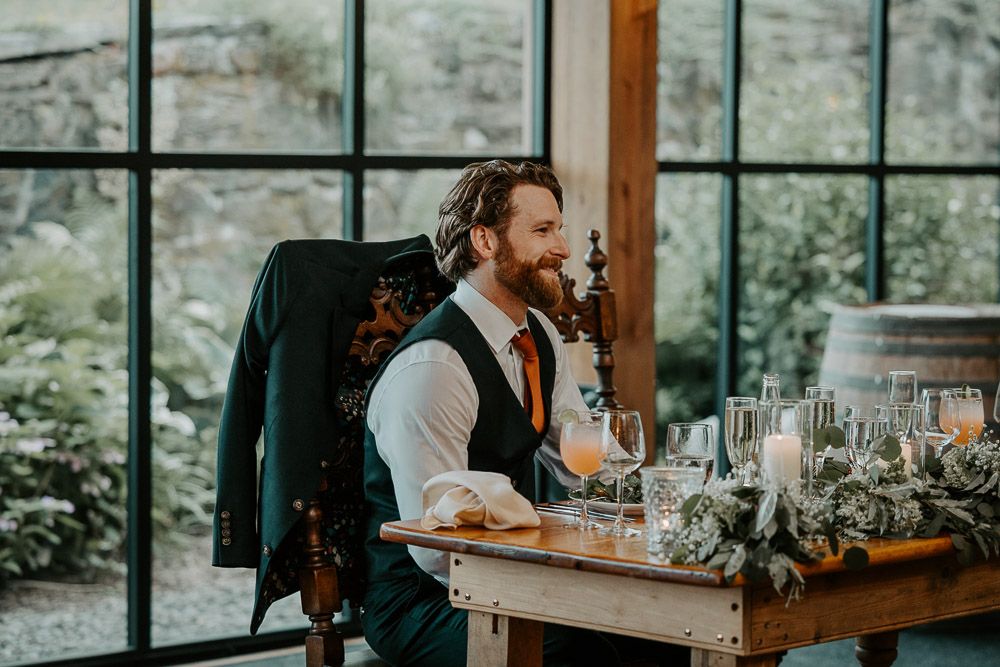 Groom at red maple vineyard wedding reception