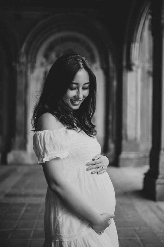 Pregnant woman in central park at bethesda terrace during maternity photoshoot