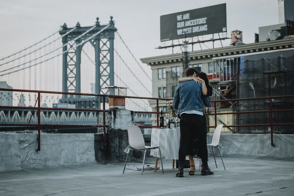 Couple on dumbo rooftop during brooklyn proposal