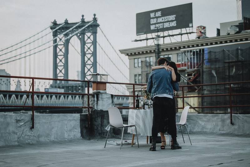 Couple on dumbo rooftop during brooklyn proposal