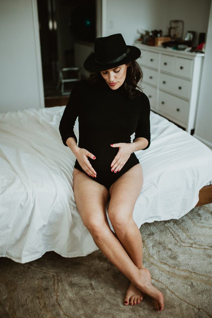 Pregnant woman with black bodysuit during maternity photoshoot in brooklyn home