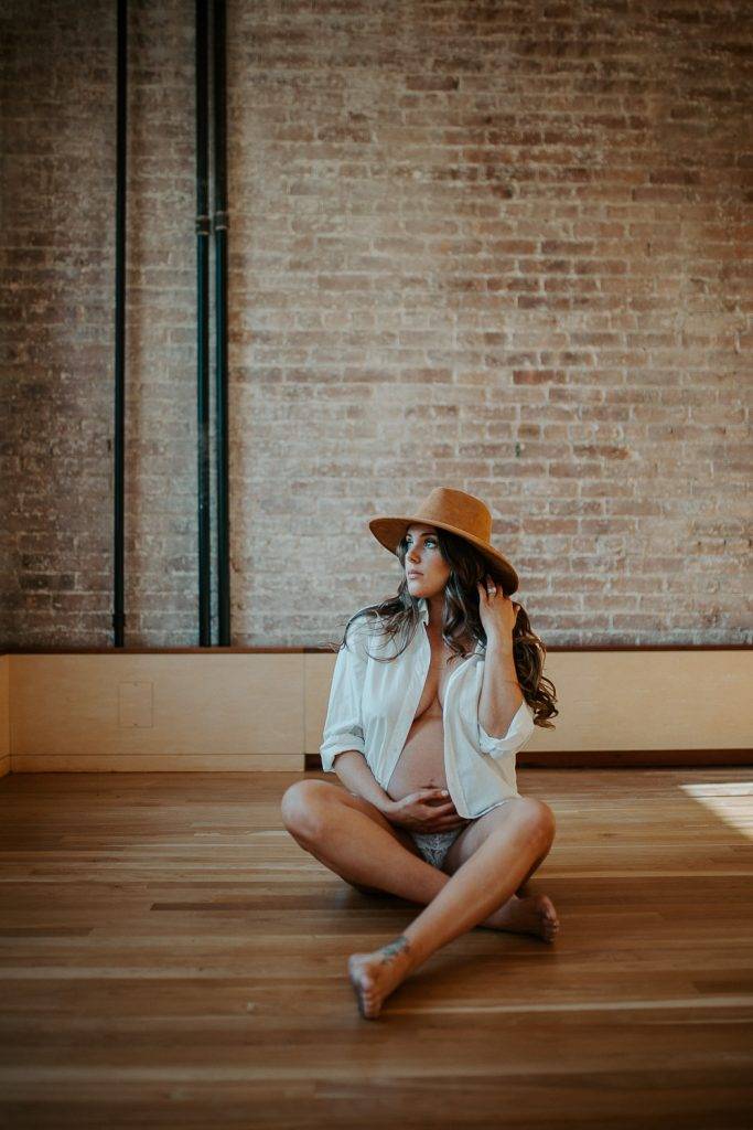 Naked pregnant woman during maternity session in nyc home