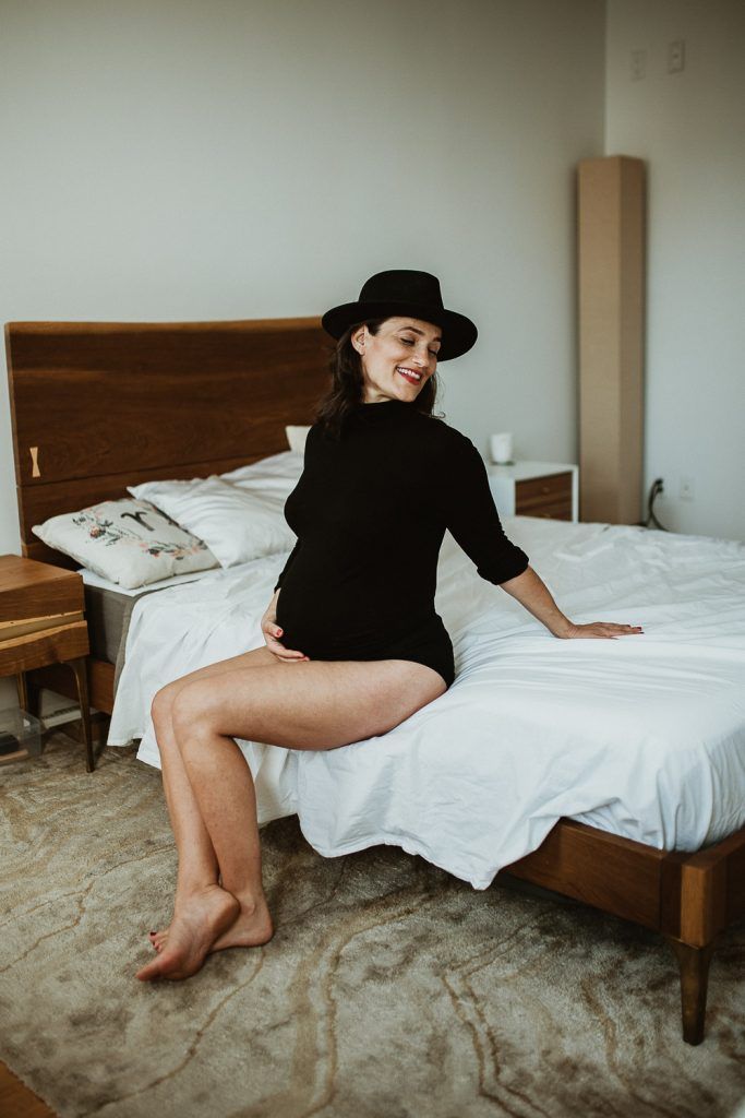 Pregnant woman with black bodysuit during maternity photoshoot in brooklyn home
