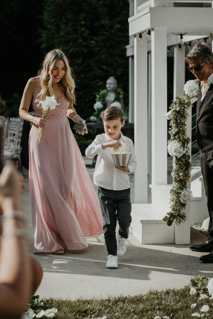 Flower boy at backyard wedding in the hamptons