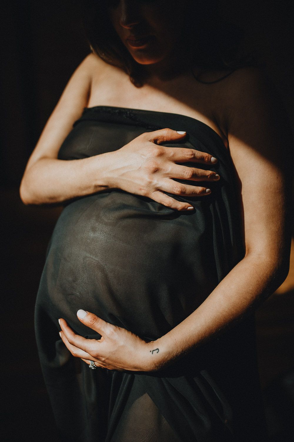 Belly close up during intimate maternity session in nyc home