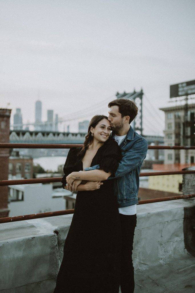 Couple on dumbo rooftop during brooklyn engagement session