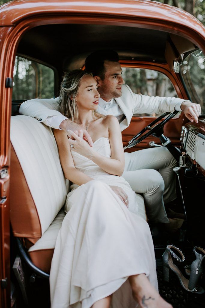 Bride and groom in vintage Ford truck at hamptons wedding