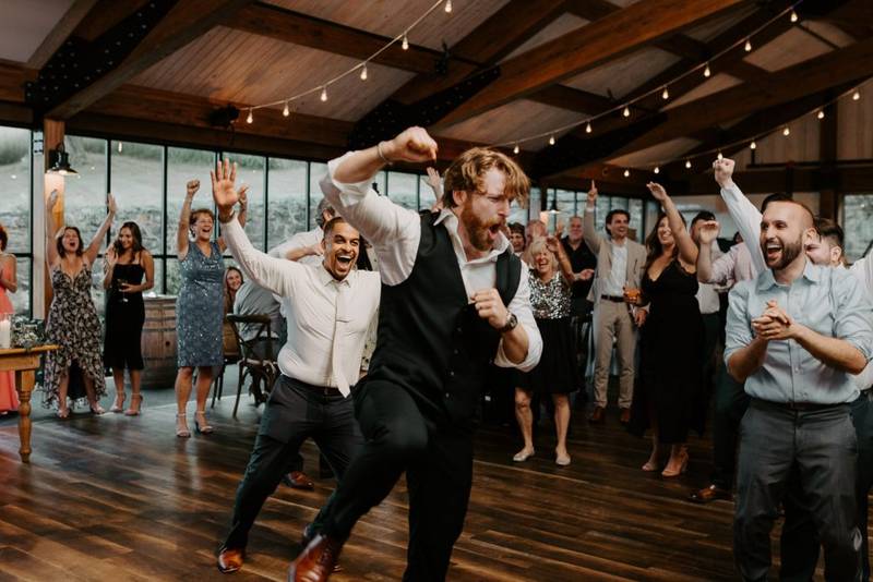 Groom dancing at red maple vineyard wedding reception