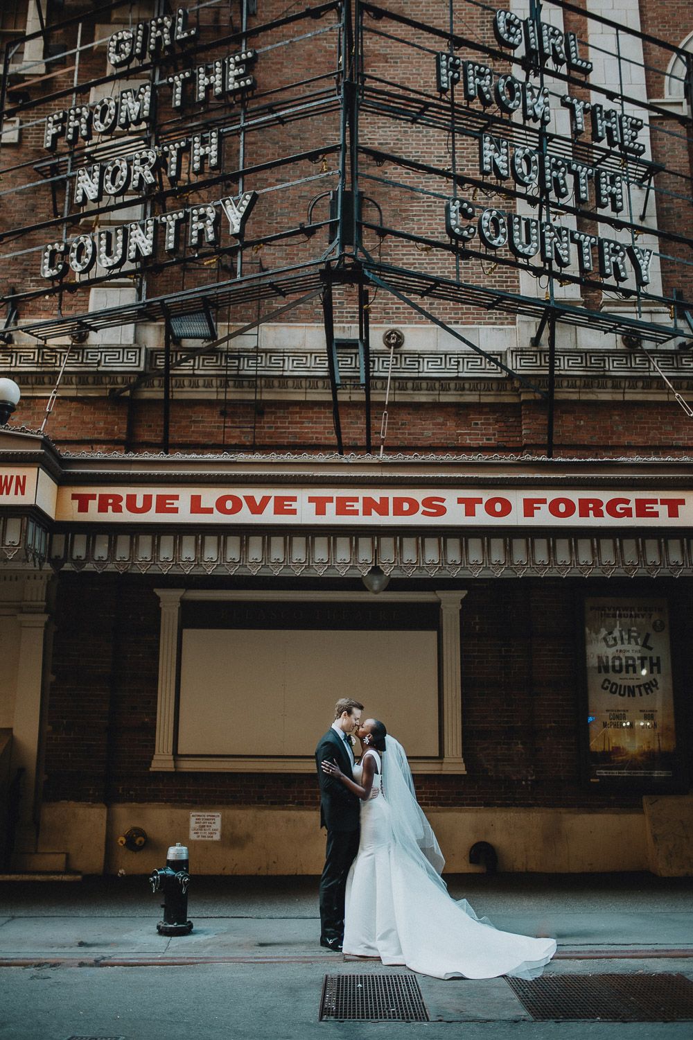 Interracial bride and groom at nyc wedding in theatre district