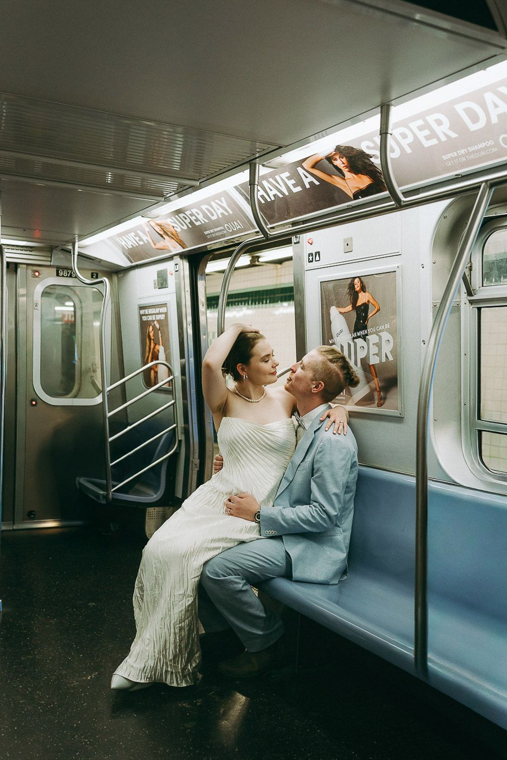 Bride and groom in nyc subway on wedding day