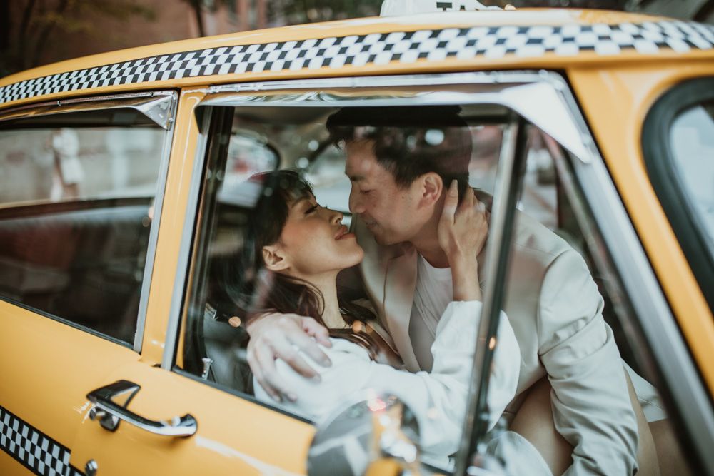 Bride and groom in vintage taxi cab during nyc elopement photoshoot